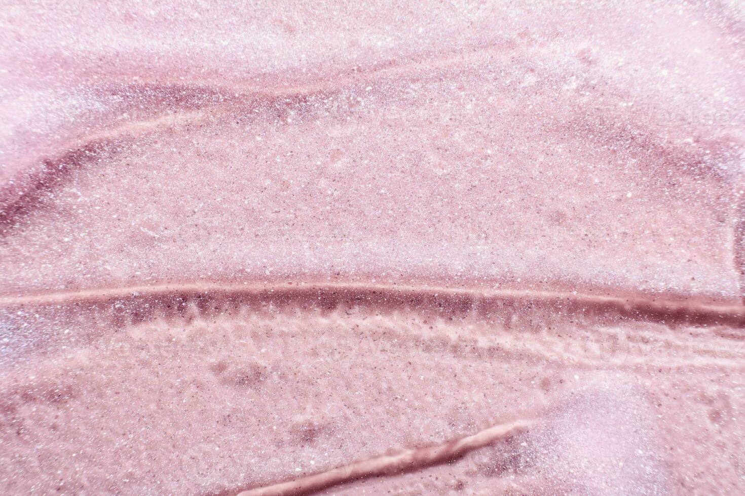 Beauty gel pink texture with particles. Shining highlighter background with brush strokes photo
