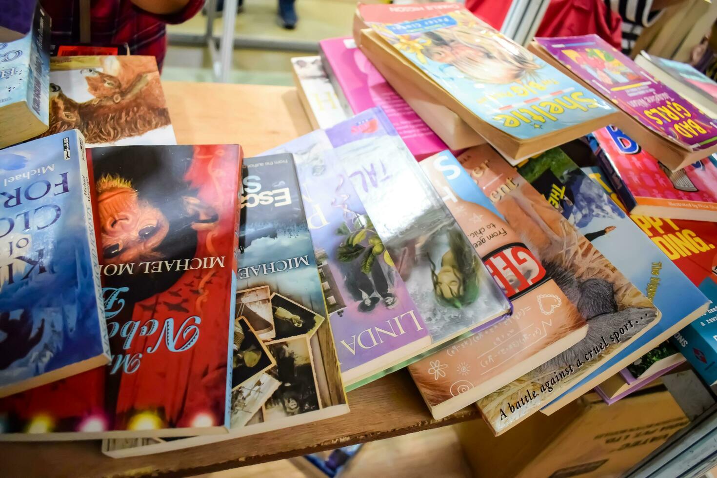 New Delhi, India, September 09 2023 - Variety of Books on shelf inside a book-stall at Delhi International Book Fair, Selection of books on display in Annual Book Fair. photo