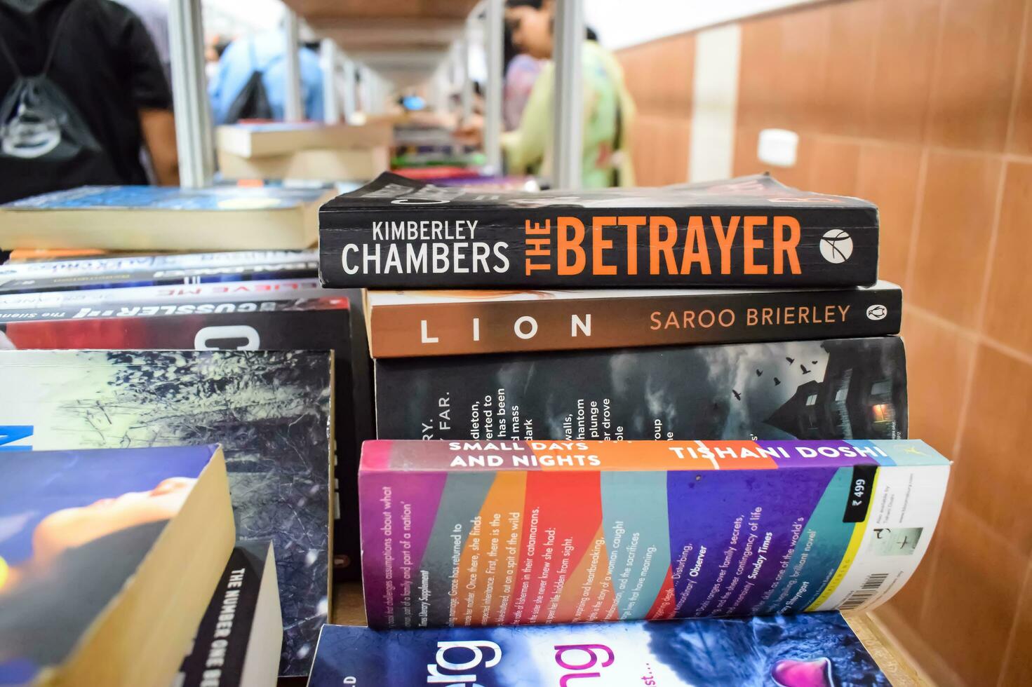 New Delhi, India, September 09 2023 - Variety of Books on shelf inside a book-stall at Delhi International Book Fair, Selection of books on display in Annual Book Fair. photo