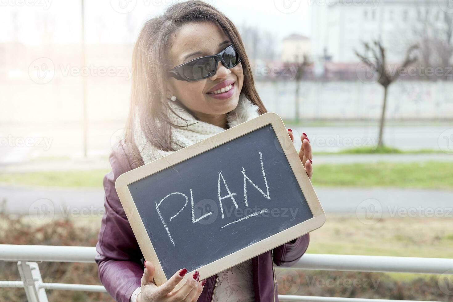 young attractive businesswoman shows a blackboard marked with business concepts photo