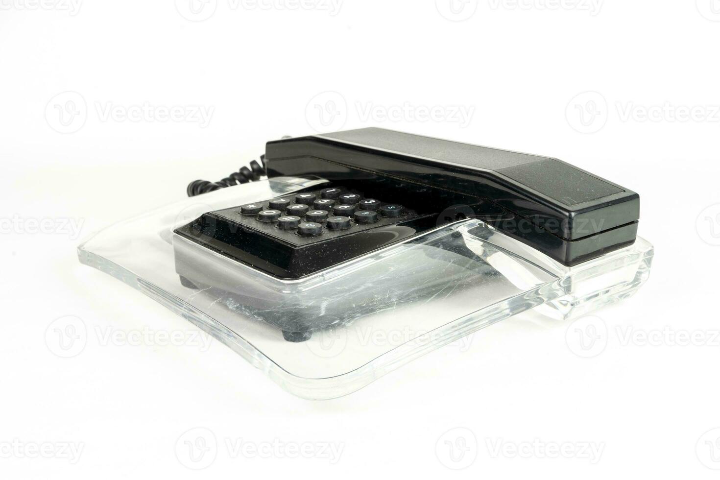 black and transparent vintage telephone over a white background photo