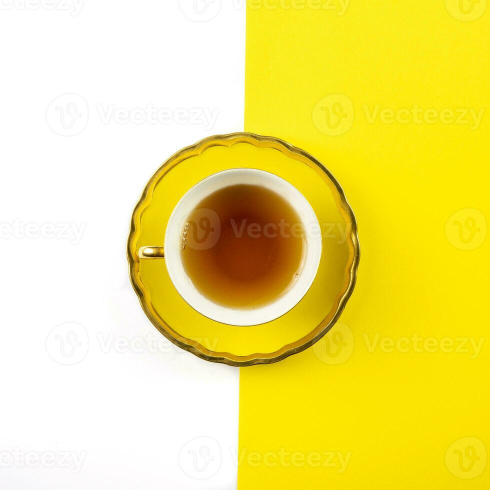 yellow tea cup on a white and yellow background photo