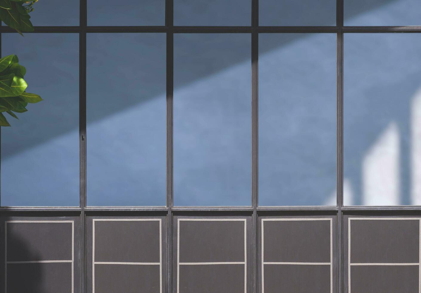 Background of glass and steel wall surface of vintage coffee shop or restaurant with sunlight and shadow on surface photo