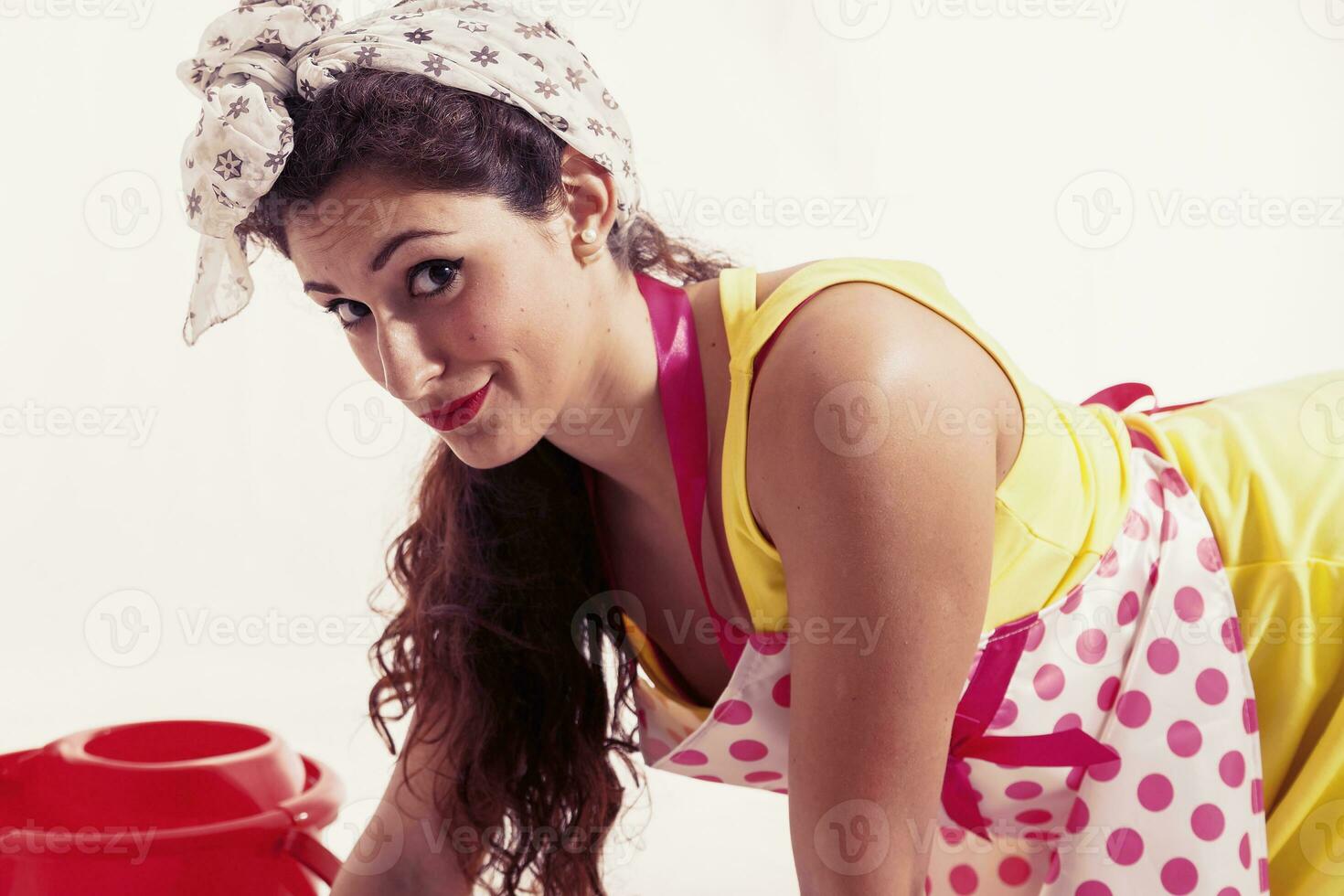 pretty housemaid with cloth and bucket cleaning the floor photo
