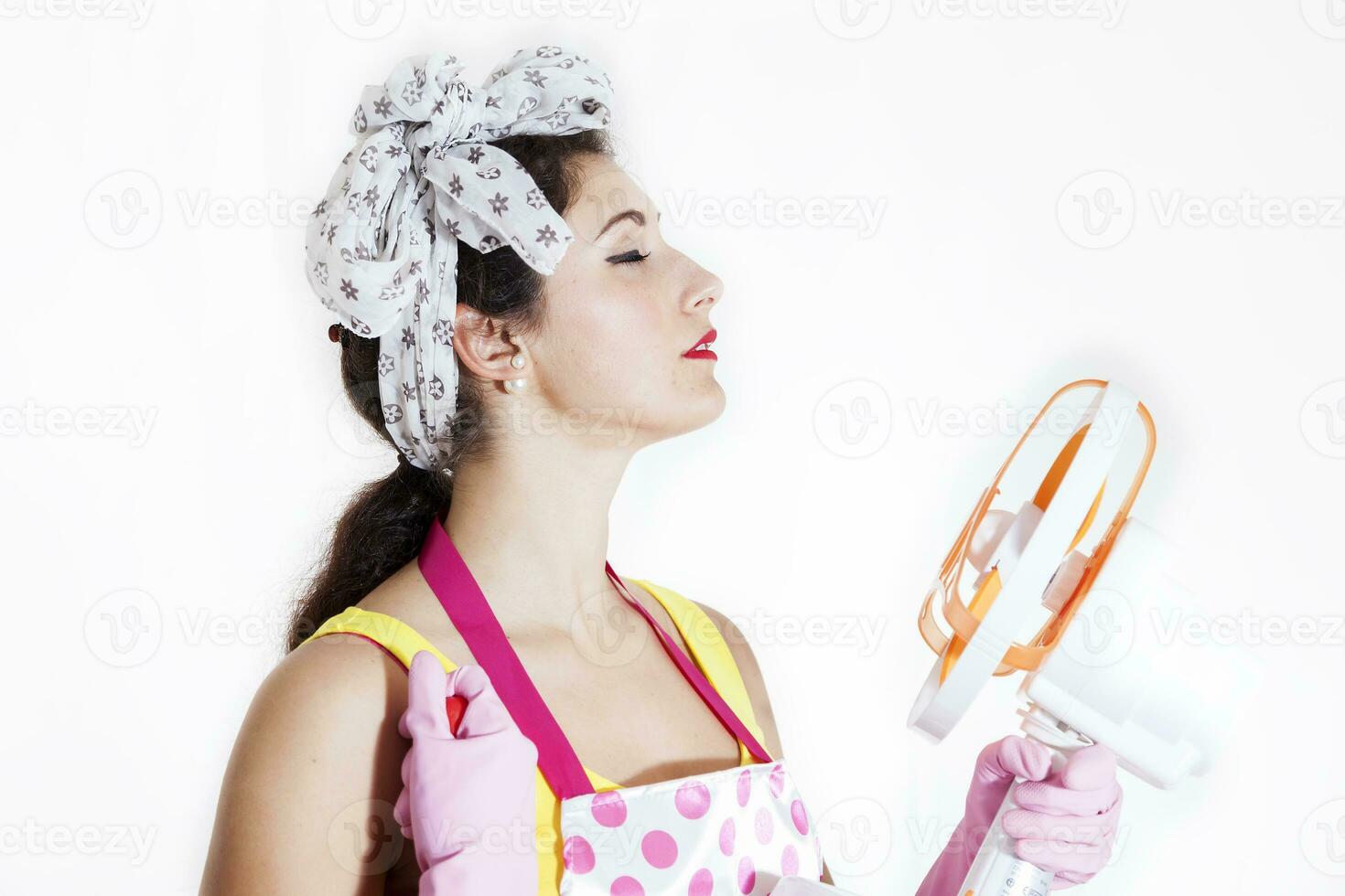 pretty cleaning lady refreshing herself with a fan photo