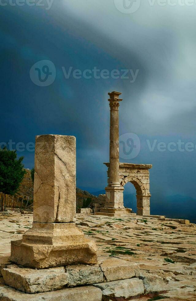Column and arches of ancient Roman agora photo