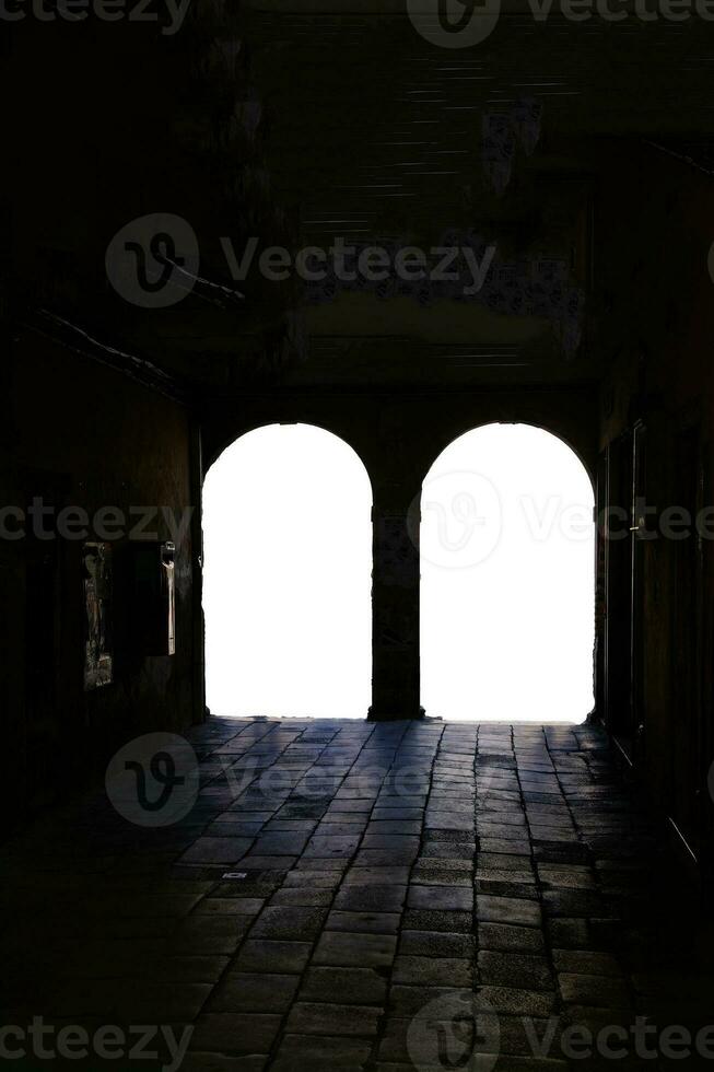 Silhouette of tourists in an arcade photo