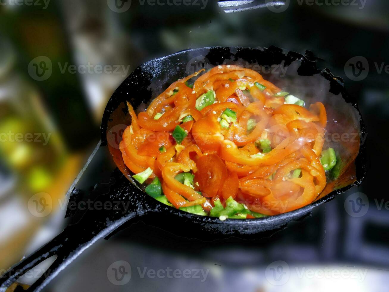 Saute of red bell pepers and jalapenos photo
