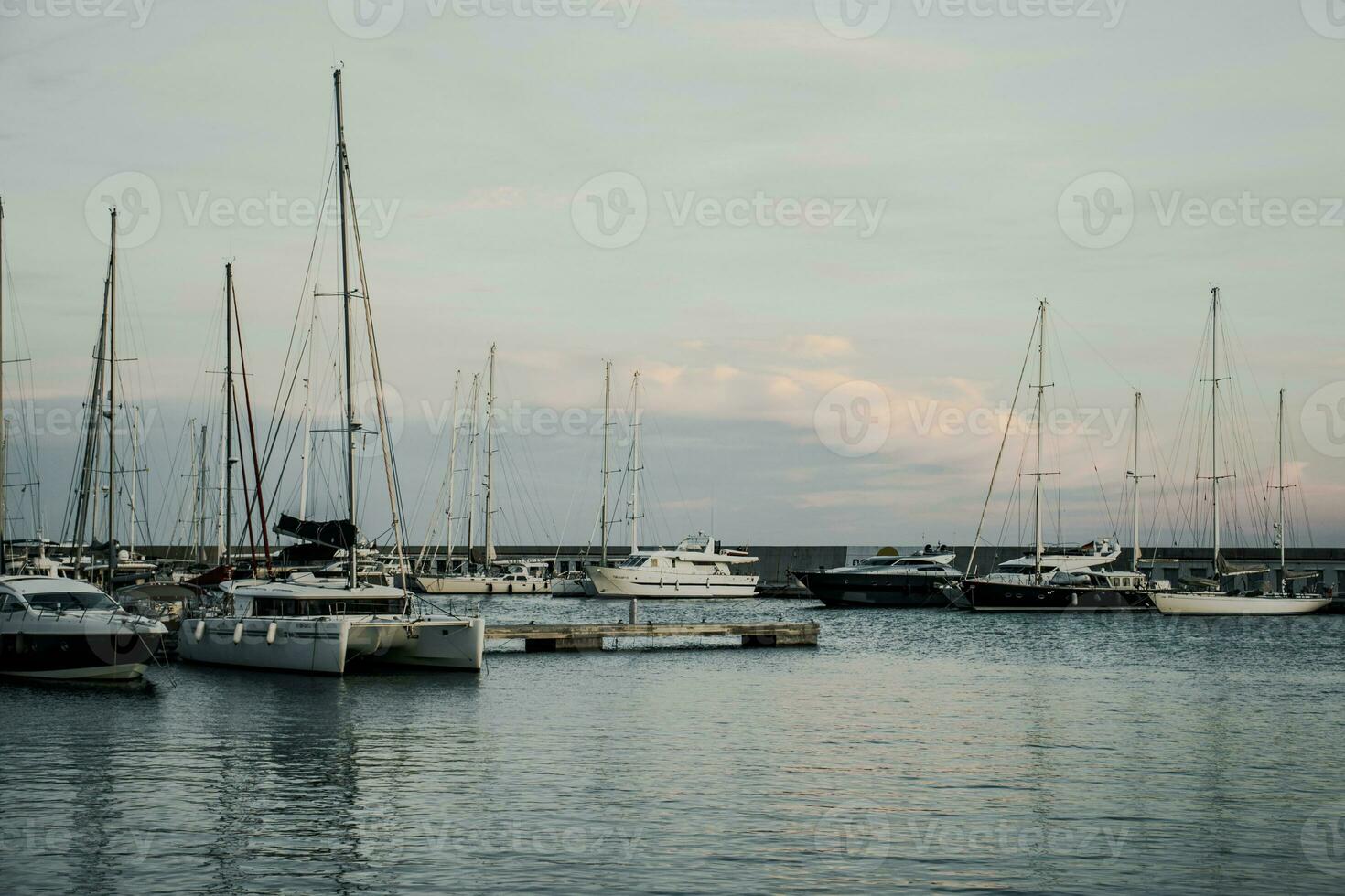 Yachts in the port, sailboats modern water transport. Olympic port, Barcelona, Catalonia. Many moored sail yachts. photo