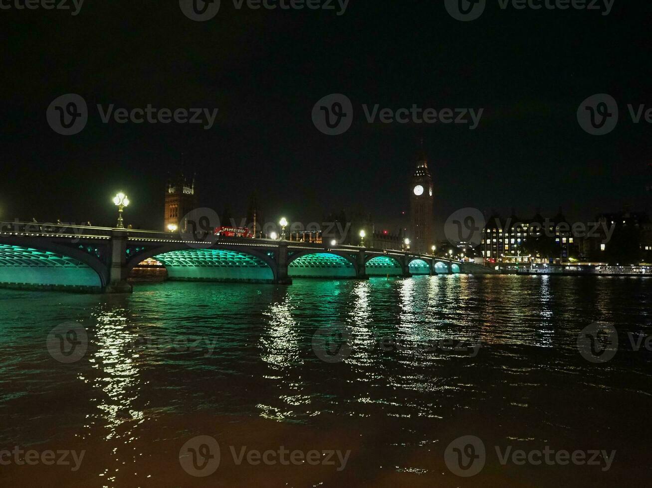 Houses of Parliament and Westminster Bridge at night in London photo