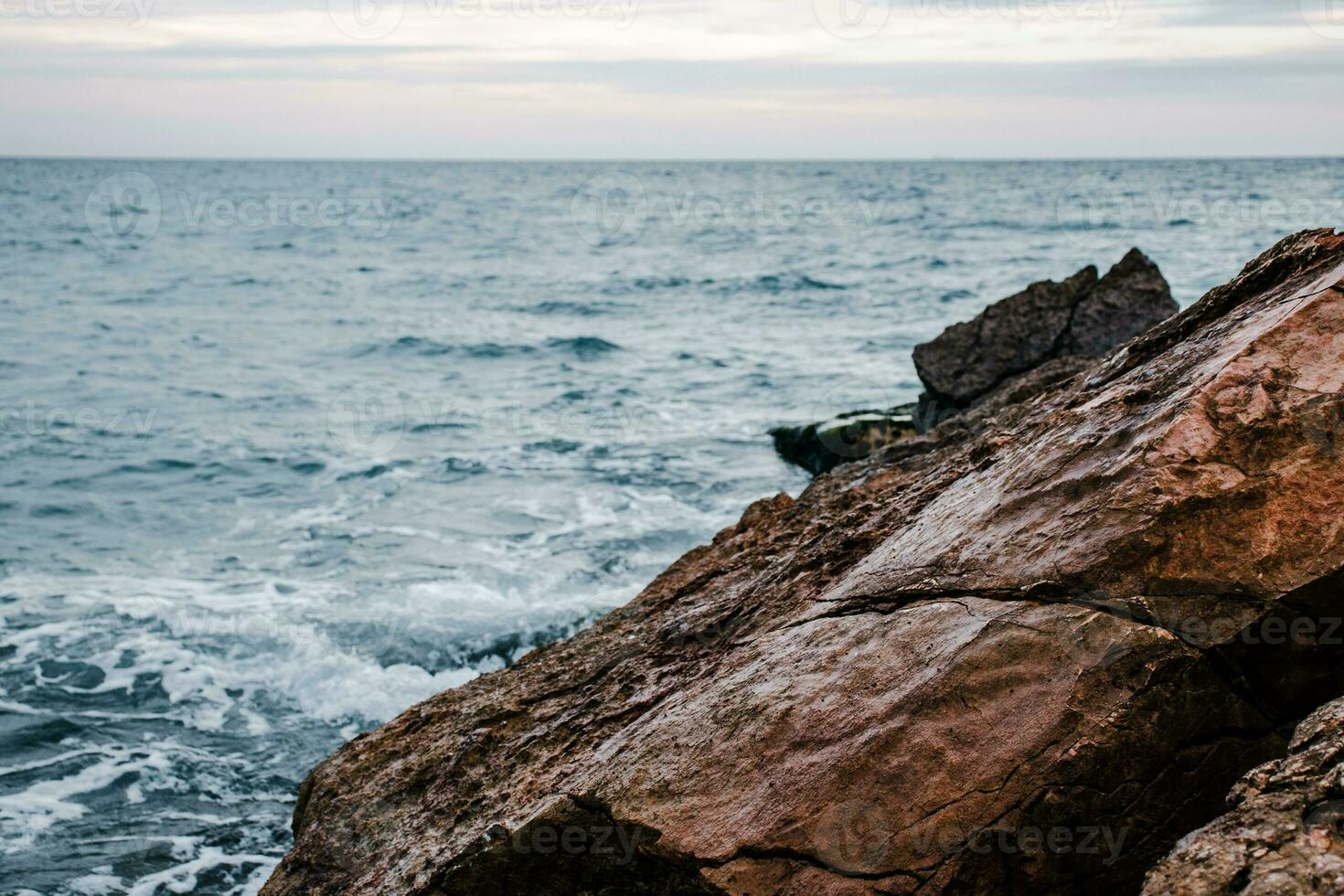 Winter sea with stones on the beach concept photo. Underwater rock. Mediterranean sea. photo