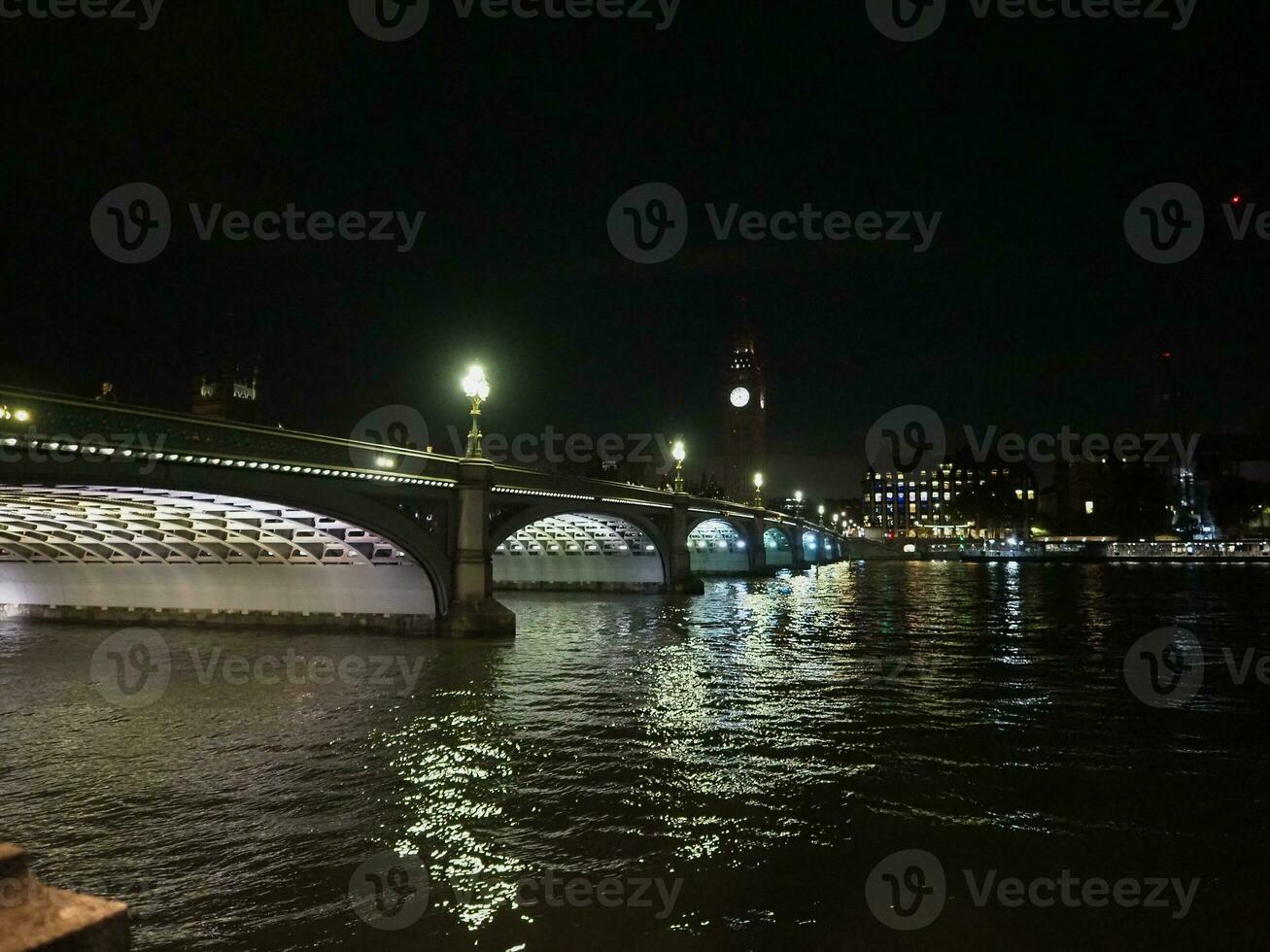 Houses of Parliament and Westminster Bridge at night in London photo