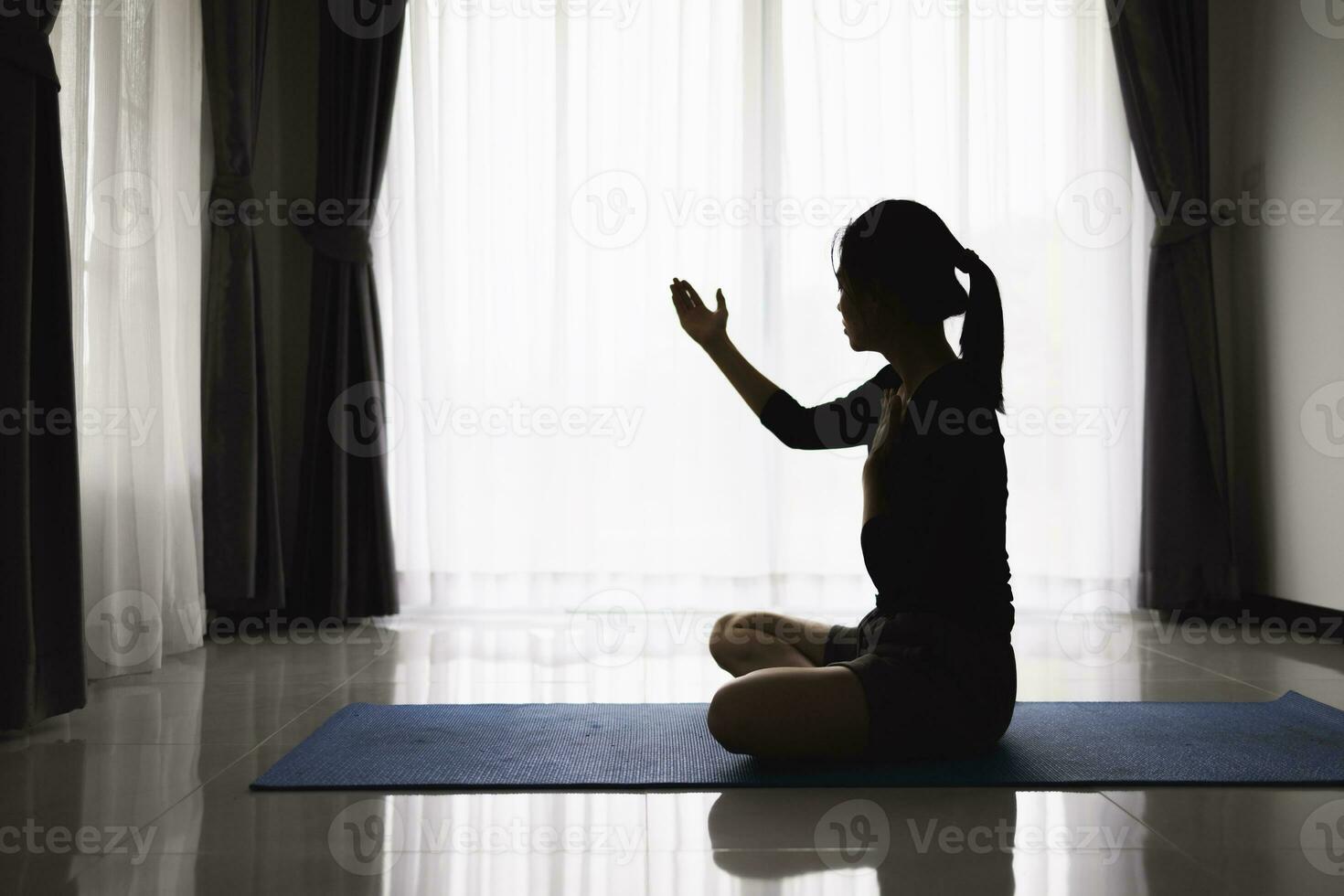 Silhouette of christian young woman praying, Christian Religion concept background. photo