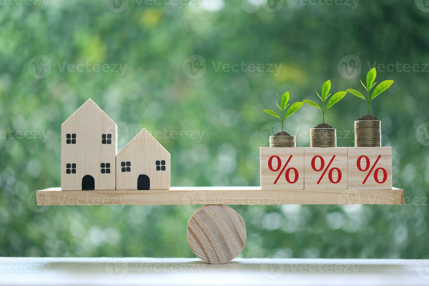 Calculating interest payments and Banking concept, Model house with Percentage symbol icon on wood scale seesaw on natural green background, Fixed Rate photo