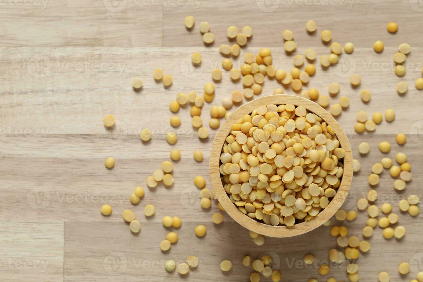 Top view of split soybeans in a bowl on wooder background, Healthy eating concept photo