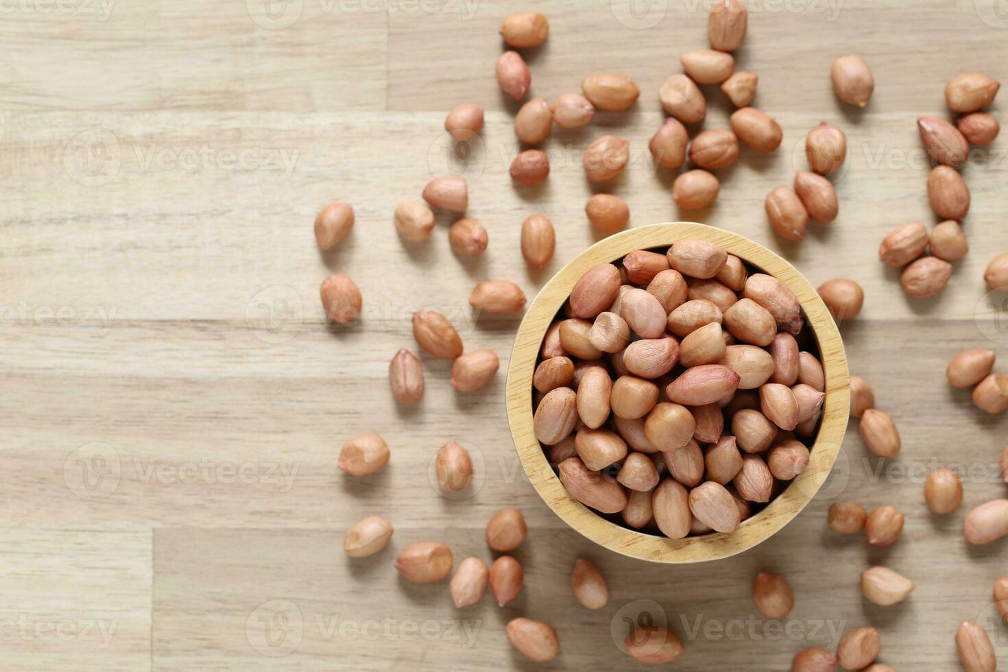 Top view of peanuts in a bowl on wooder background, Healthy eating concept photo