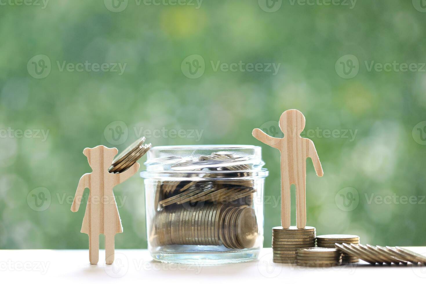 Love couple putting a coin into the glass bottle on green background, Finance, Saving for lover or family and save money for prepare in future concept photo