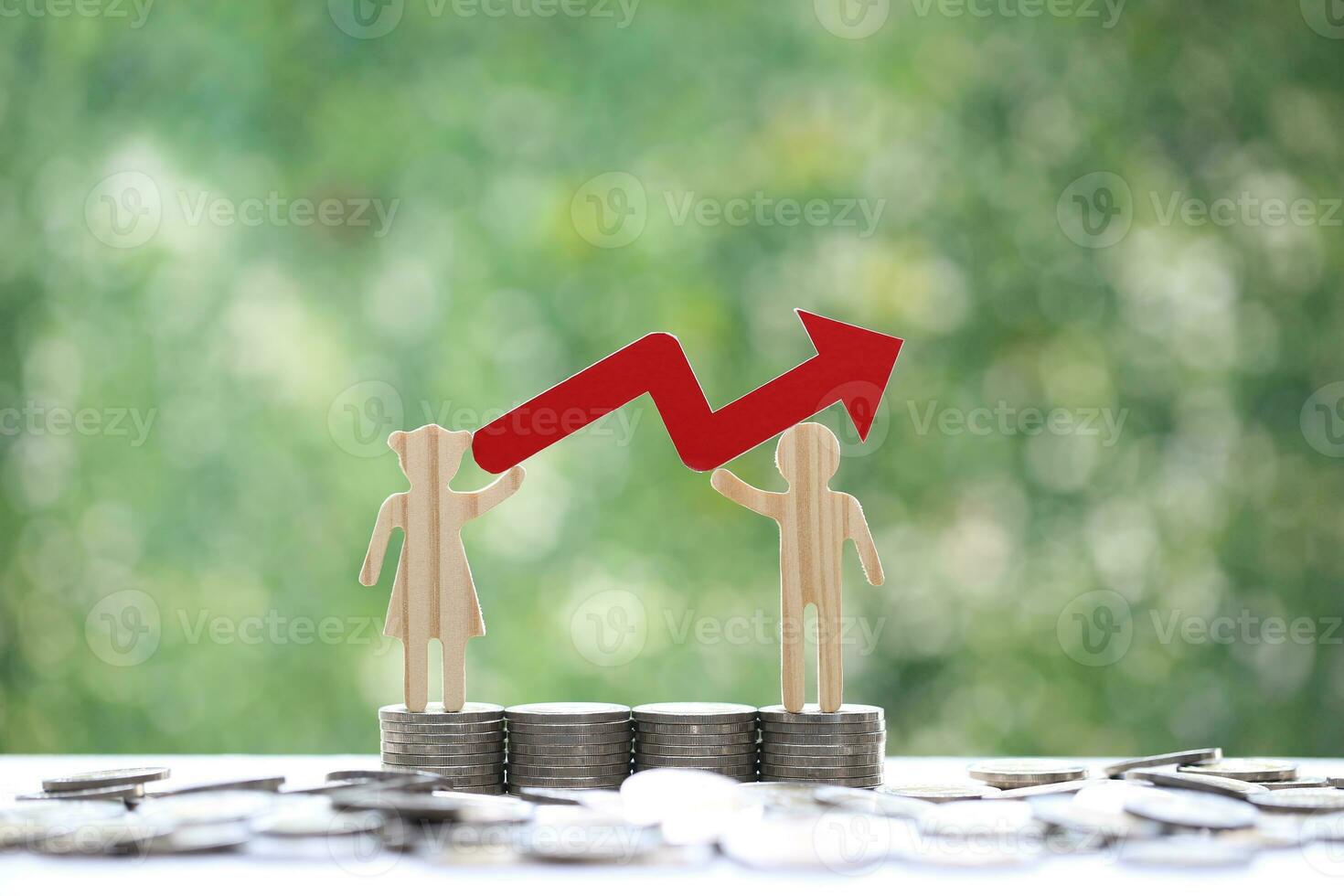 Love couple holding red arrow graph and stack of coins money on natural green background,Business investment and real estate concept photo