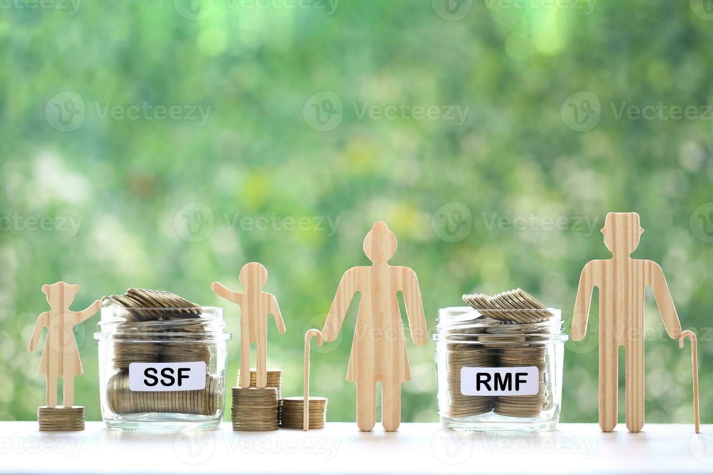 Model family with coins money in glass bottle on natural green background photo