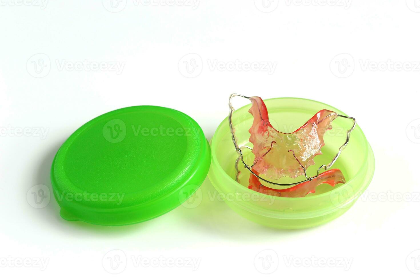 Acrylic dental retainer in box on white background, Healthy teeth and tooth hygiene concept photo