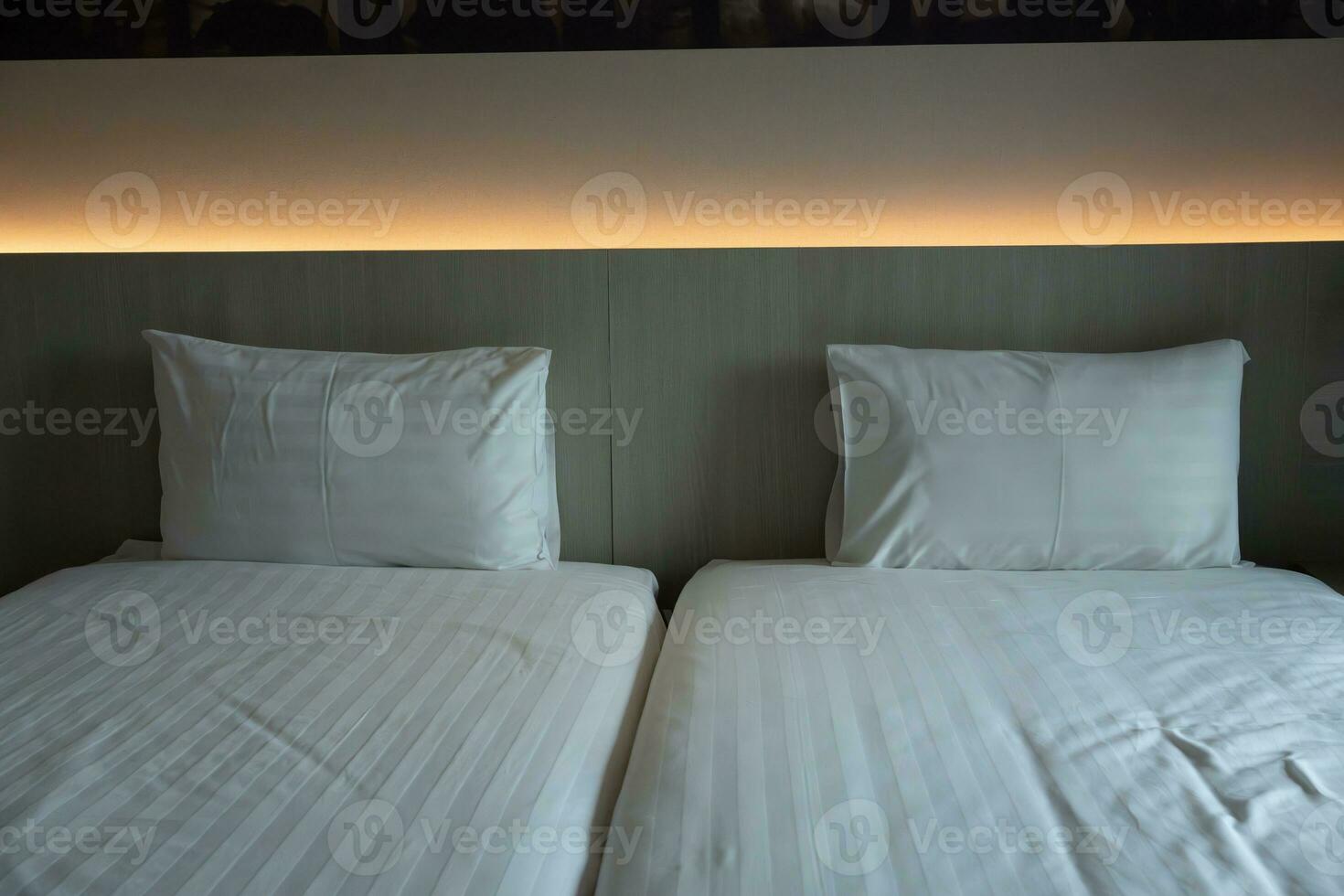 Two bed of clean bedding sheets and pillow photo