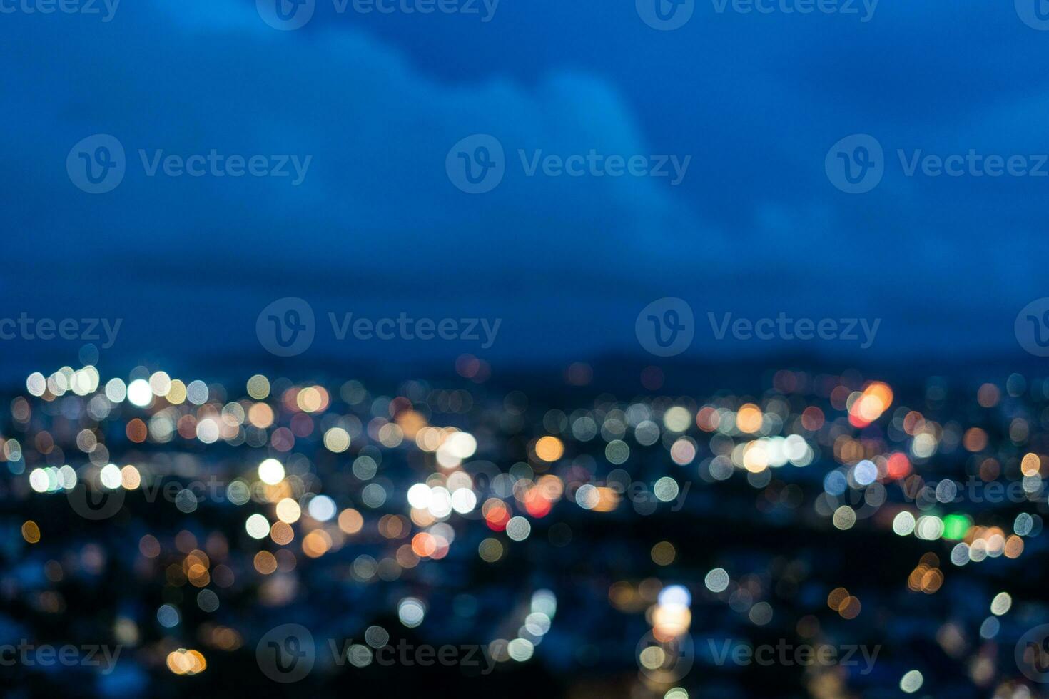 Bokeh and defocused image of illuminated lights and sky at twilight photo