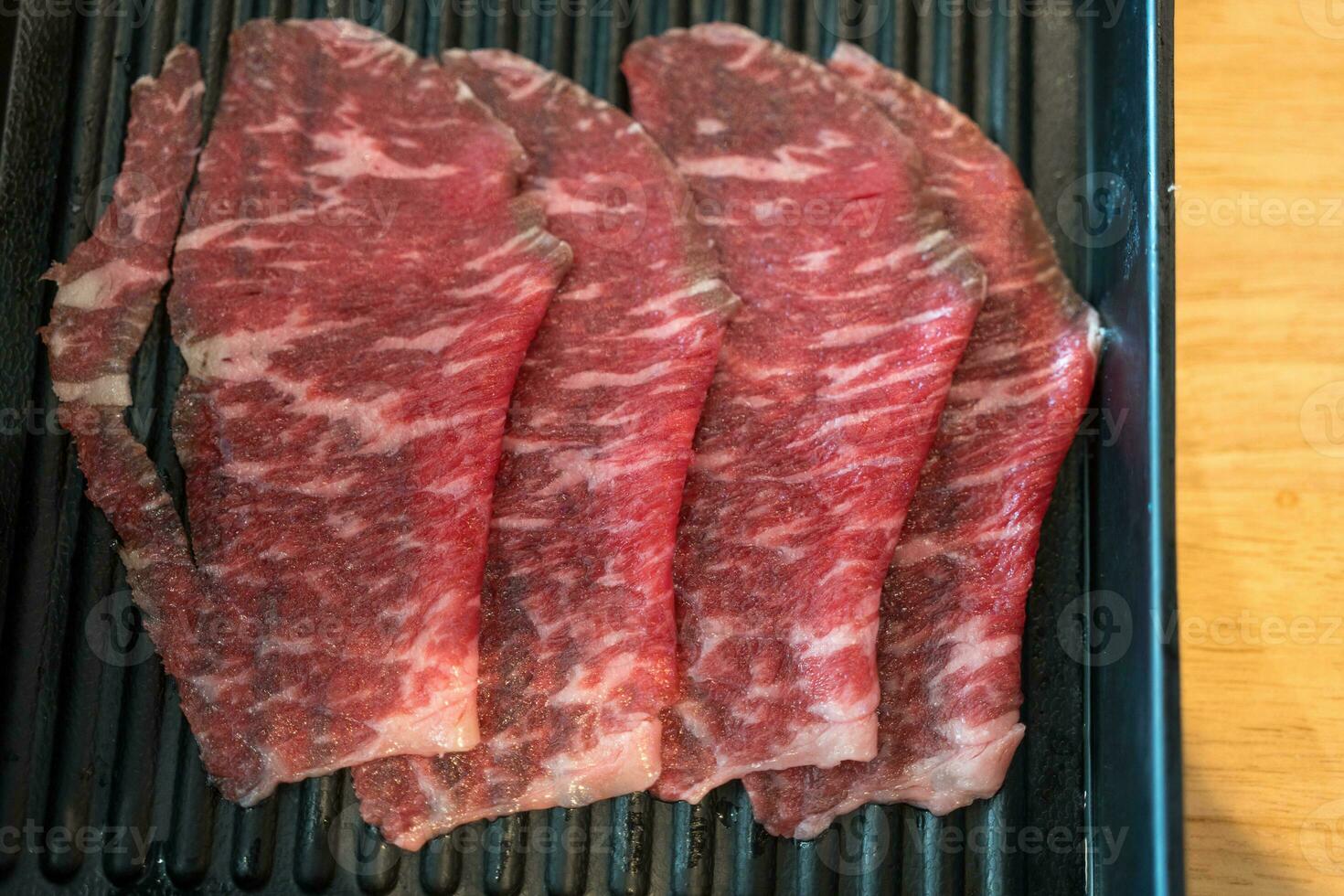 A close up detailed image of sliced Japanese wagyu beef photo
