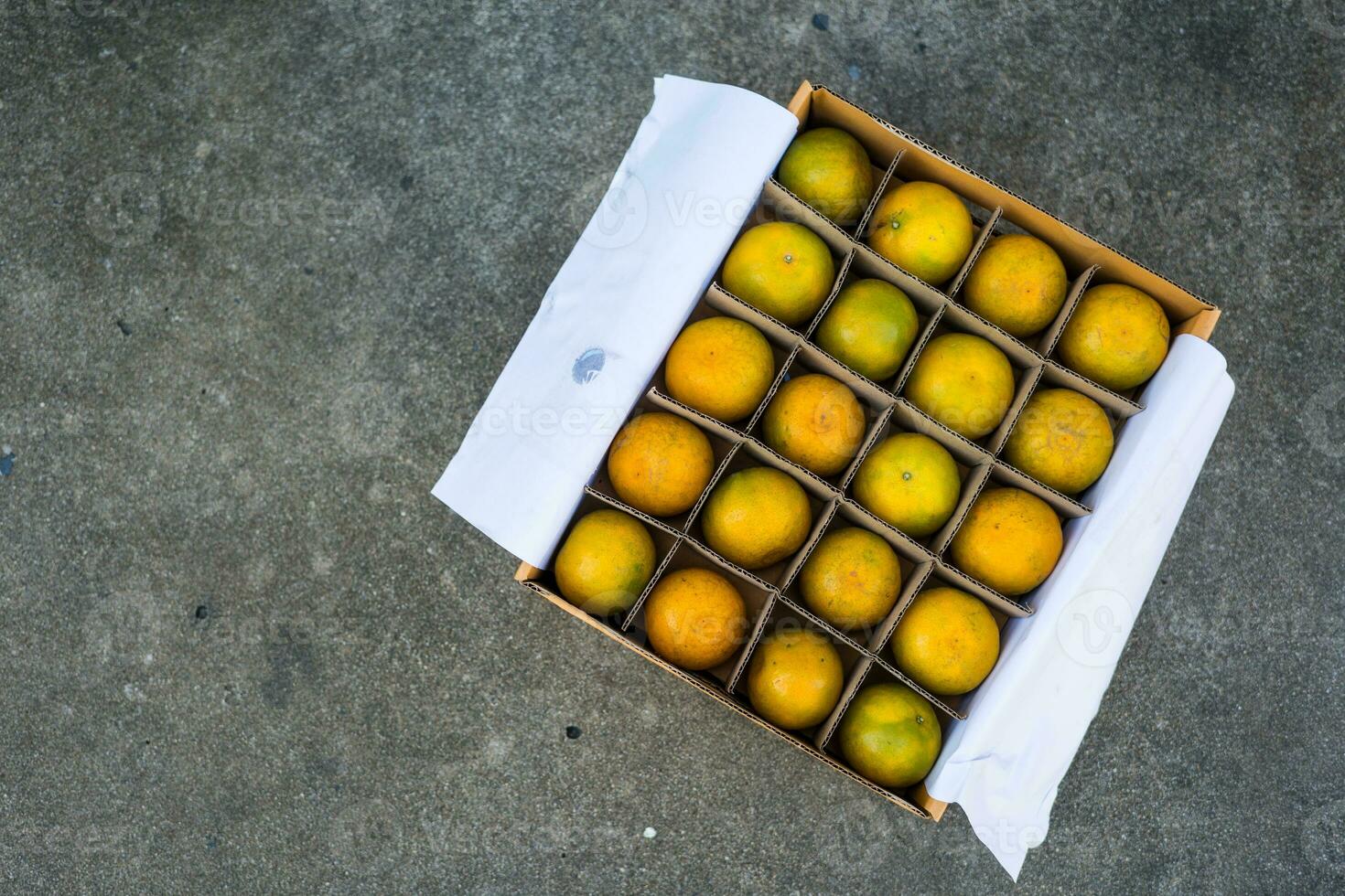 Fresh oranges in layers on the brown paper carton box order from order photo