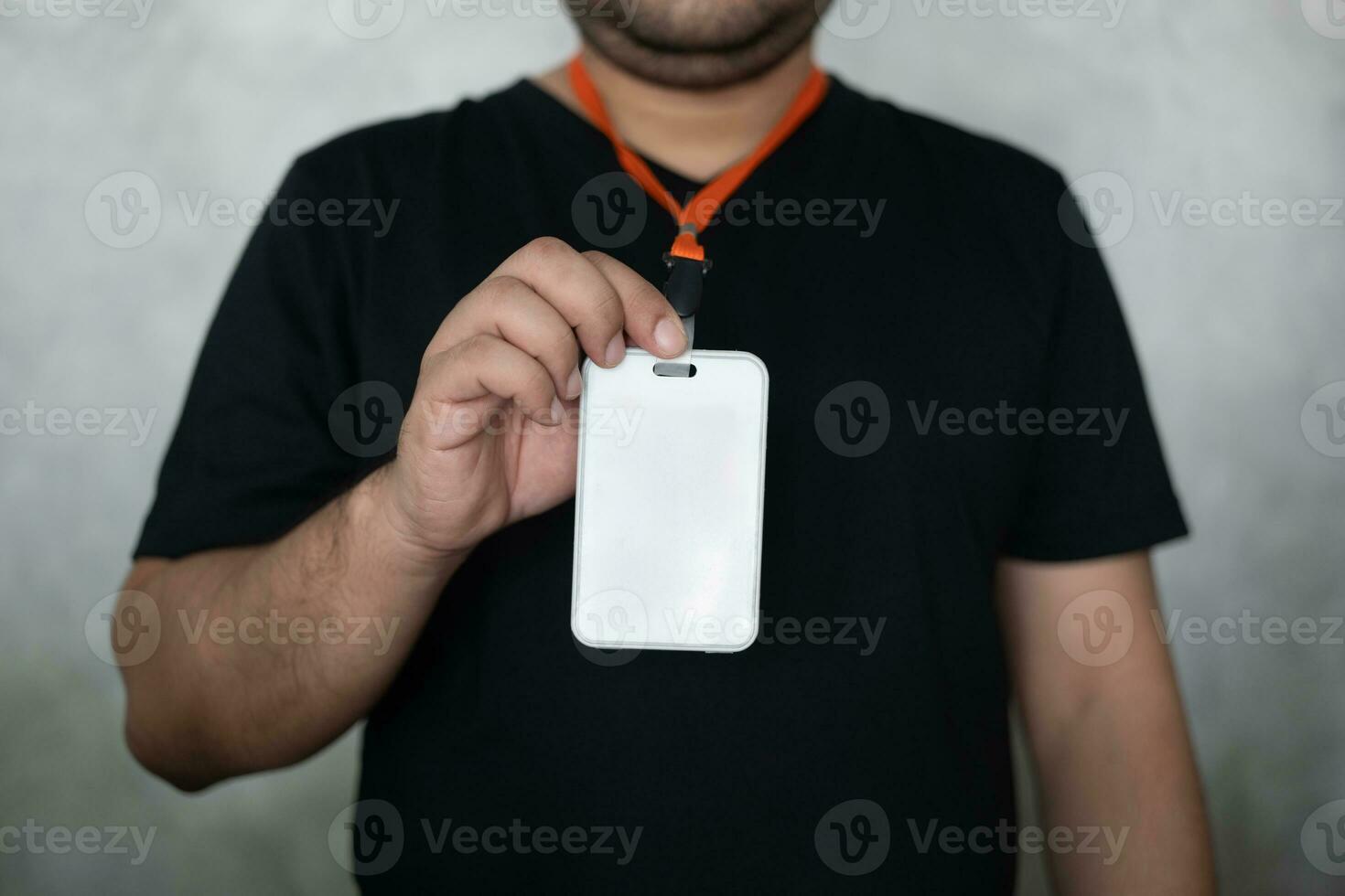 Male hand showing blank white badge on grey background photo