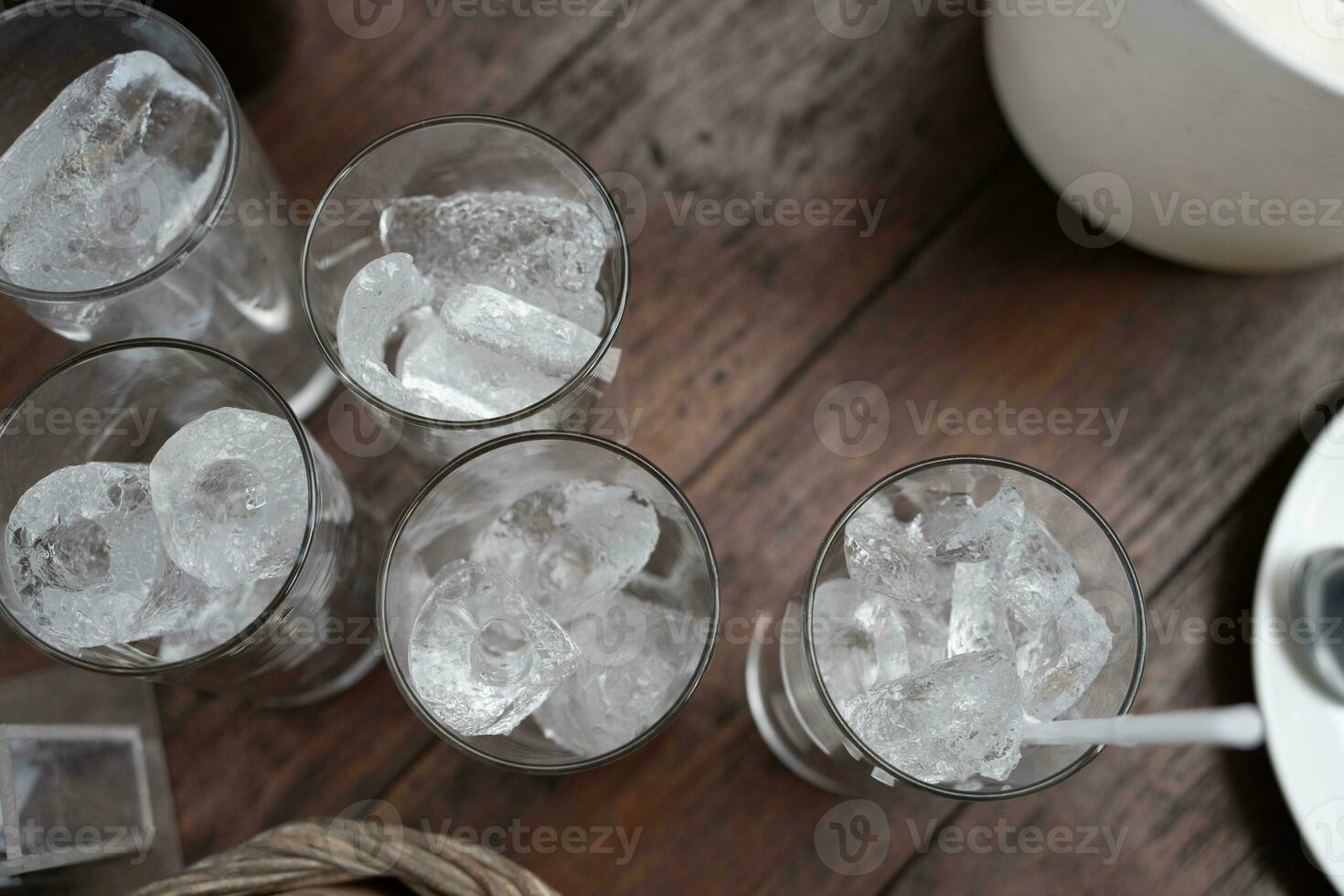 Many glass of ice in clear glass cup in table dinner photo