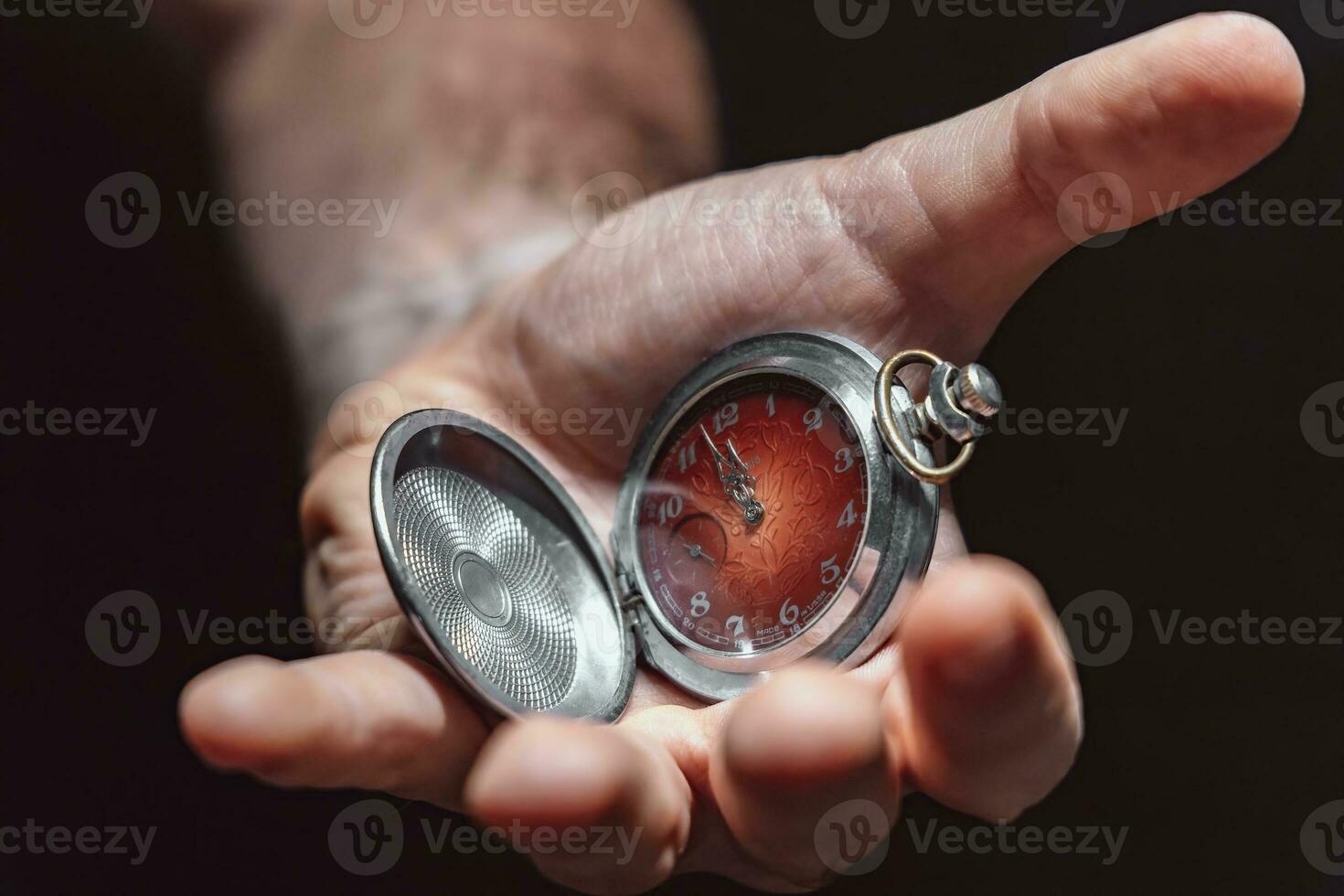 Clock showing time in hand for business concept or motivating theme photo