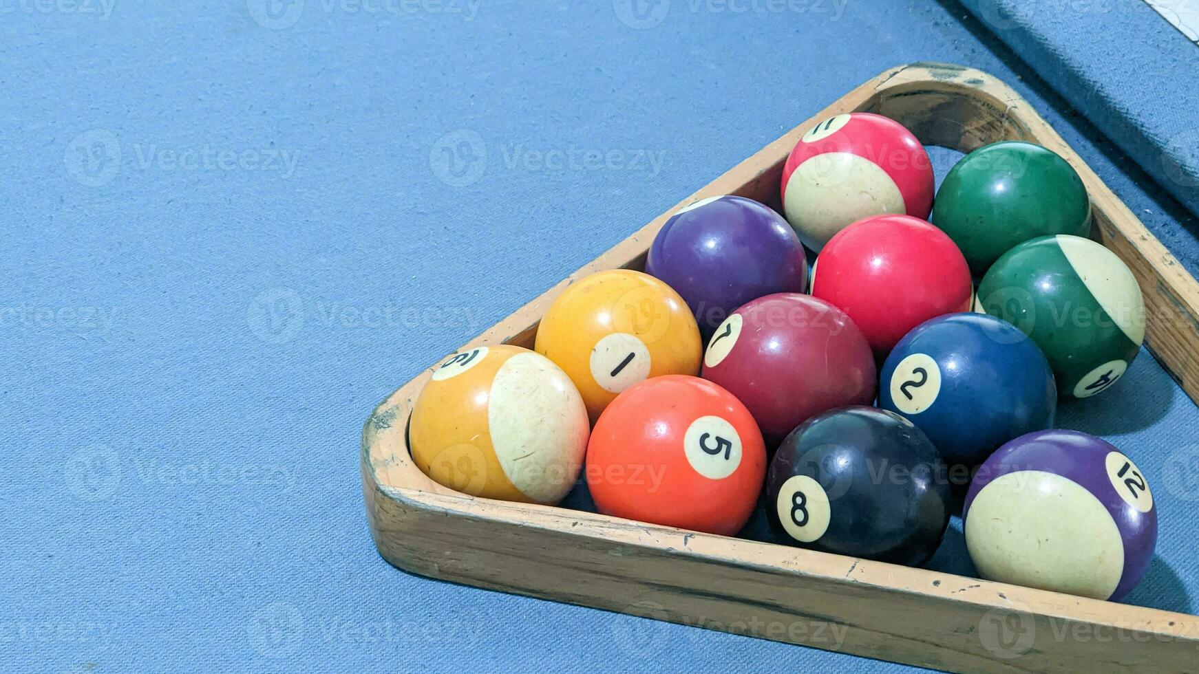 Billiard balls in a wooden box on a blue billiard table photo
