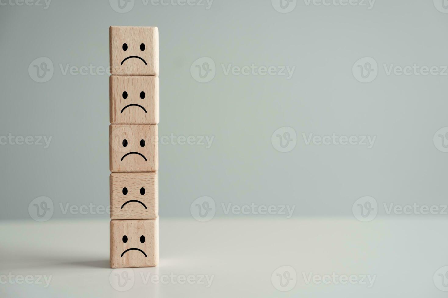 Sadness or unhappy face on stack of wooden block.no passion, feel sad, emotion, negative thinking, depressed, burnout syndromes, Low energy, world mental health day, mental health assessment concept. photo