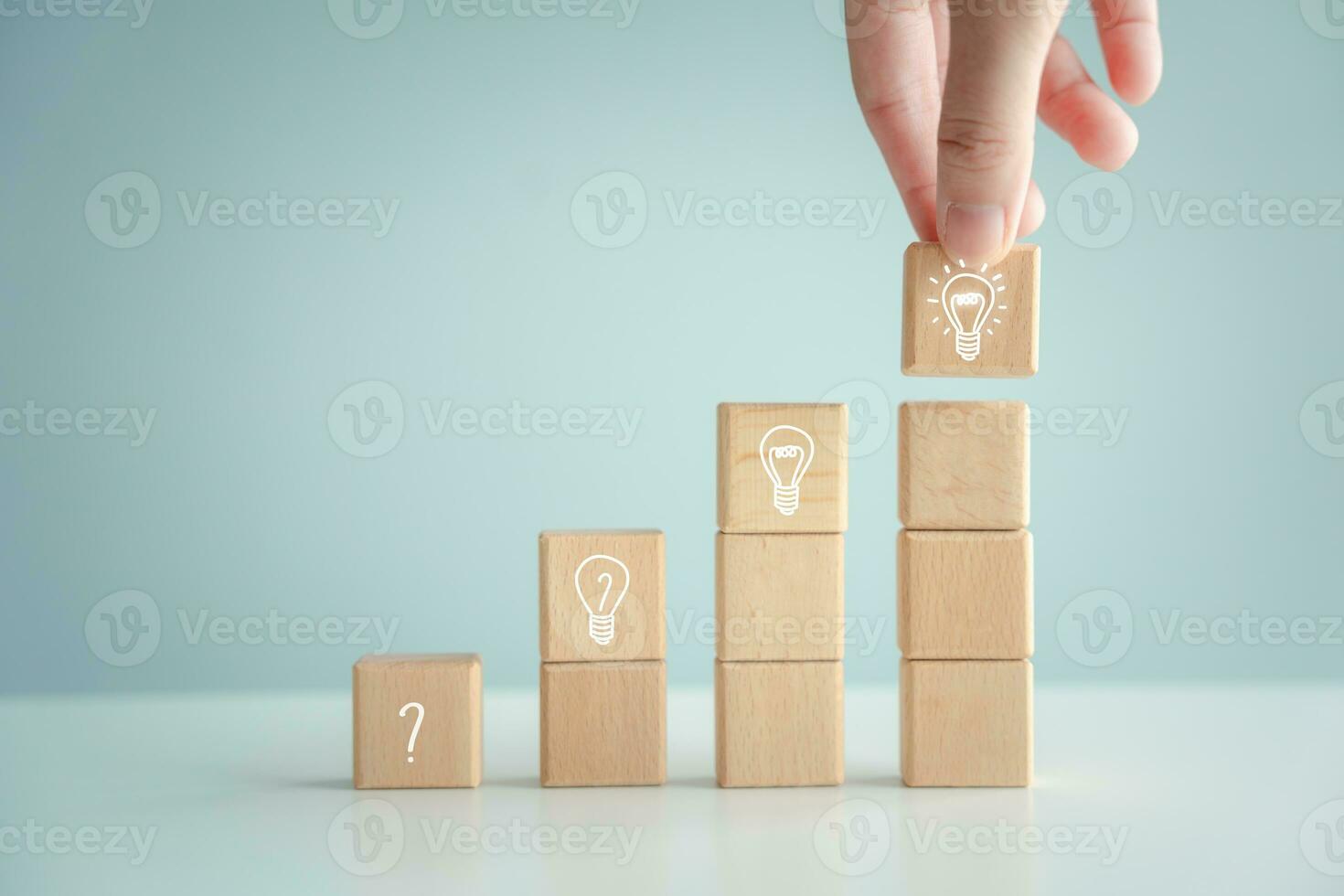 Idea and creativity concept. Creative process concept and problem solution. Hand pick glowing light bulb from step of question mark on stair to glowing light bulb for solving problem. photo