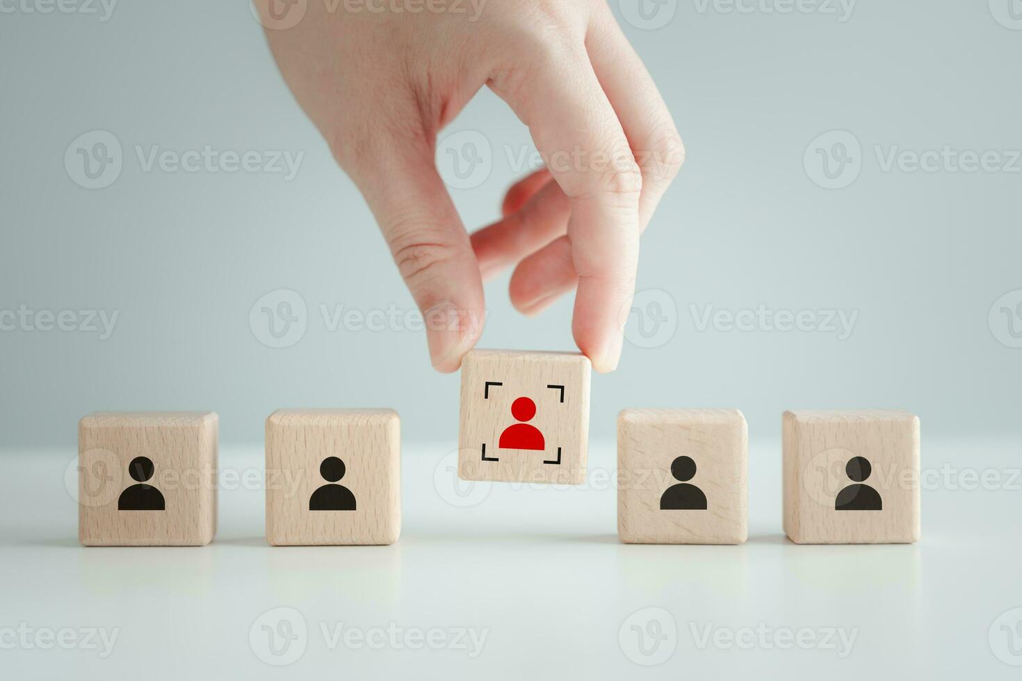 Hand choose red human icon with focus frame. Individuality, unique, difference, Business hiring and recruitment selection. Human Resource Management. Leadership. Choice of new employees to team. photo