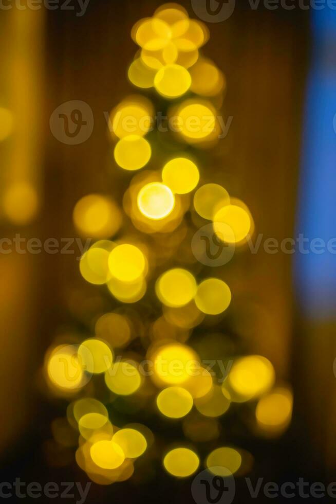 Defocused festive Christmas or New Year tree with blur bokeh lighting photo
