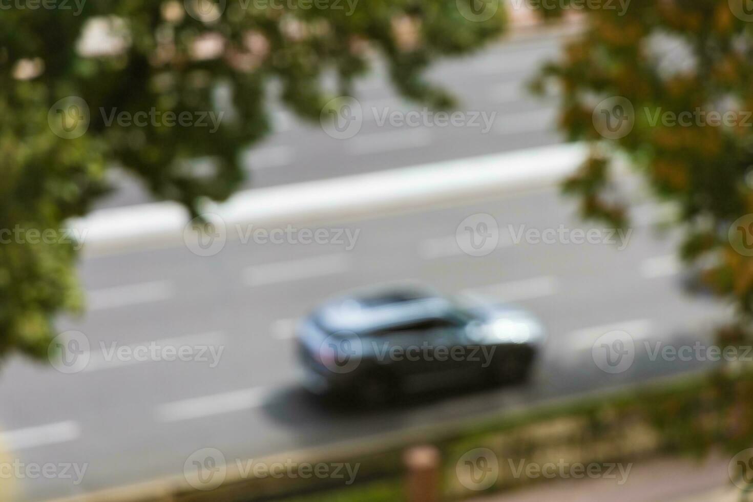 A car on the road in motion in a blurry photo. photo