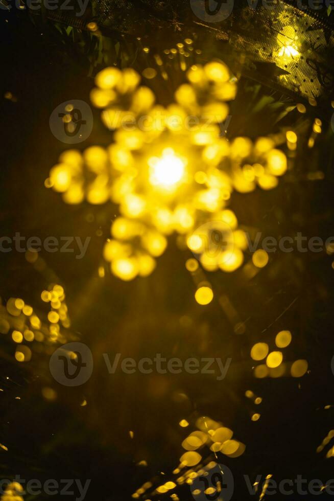 Abstract background with Christmas or New Year festive sparkling light in the form of defocused bokeh photo