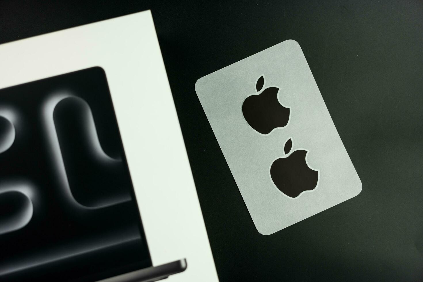 Bangkok, Thailand - December 24, 2023 Black Apple Computers logo sticker comes with MacBook Pro M3,the latest MacBook Pro in 2023 photo