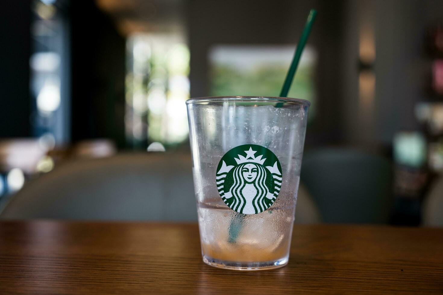 Bangkok, Thailand - January 7, 2024 Close up a crystal glass with Starbucks logo after drink finish photo