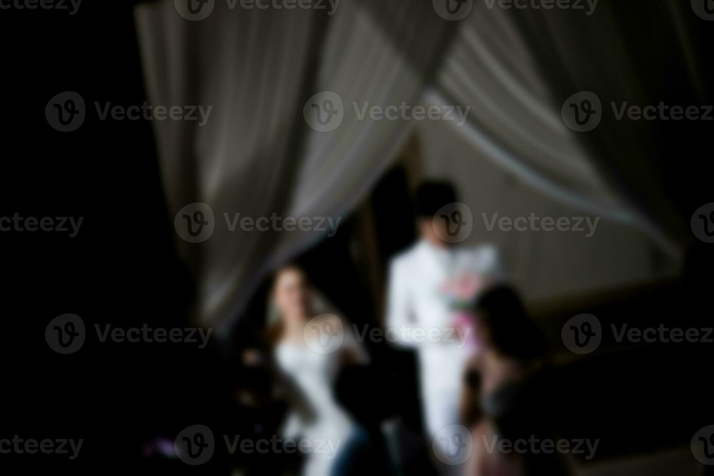 Blurred background the bride and groom going to stage at luxury wedding ceremony. photo