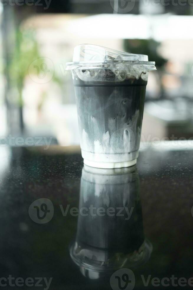 Ice charcoal latte with fresh milk it showing the texture and refreshing look of the drink photo