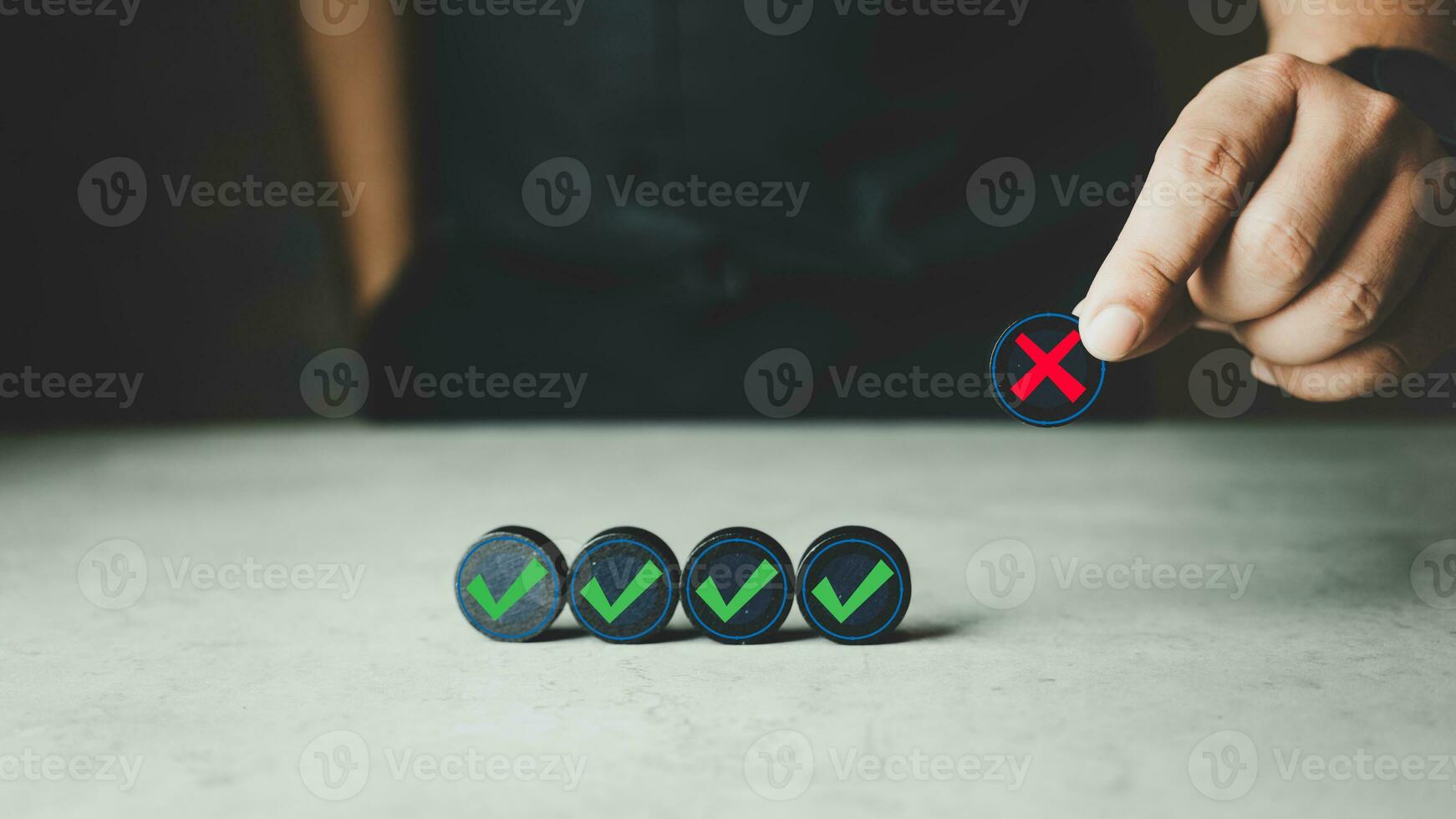 Businessman selects red cross sign mark between the green correct sign mark which print screen on black wooden cube photo