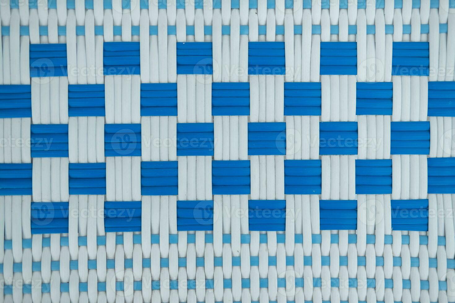 Texture of white and blue synthetic fabric. Perpendicularly woven white and blue plastic threads. photo