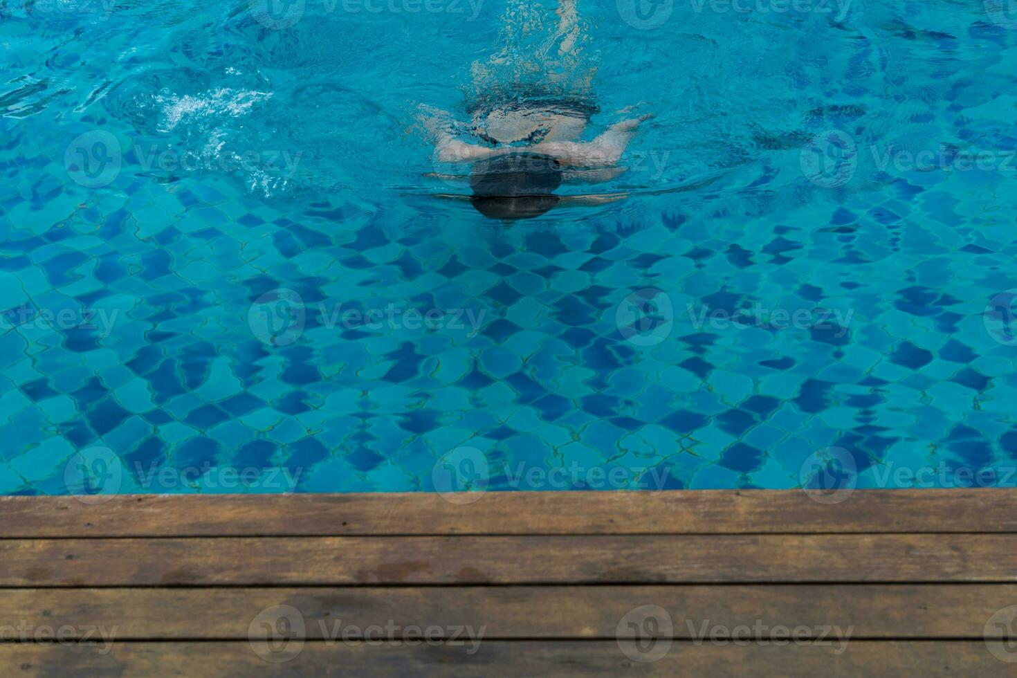 Man floating in swimming pool photo