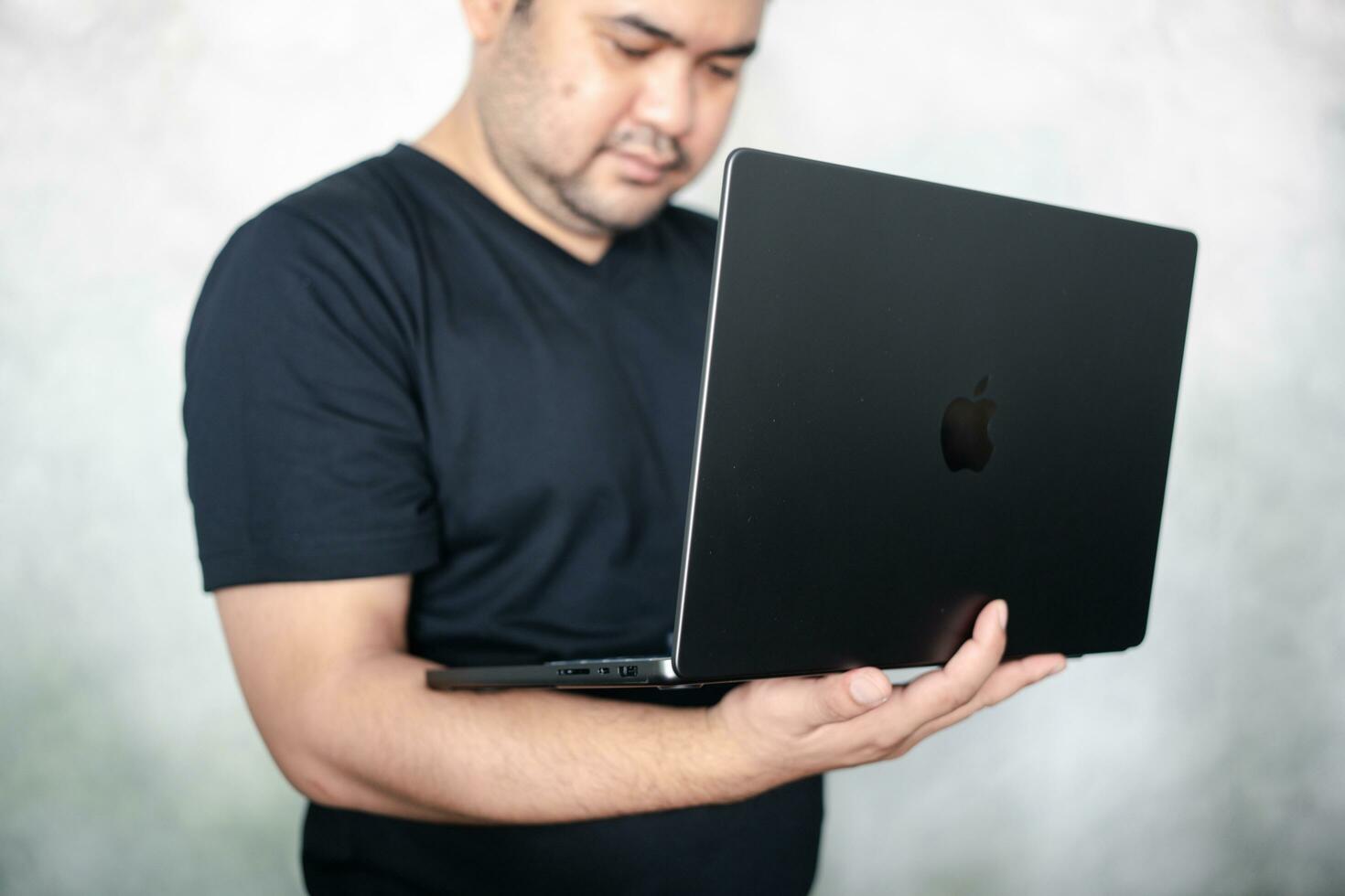 Bangkok, Thailand - January 6, 2024 Man use and test Apple Bangkok, Thailand - January 6, 2024 Man use and test Apple