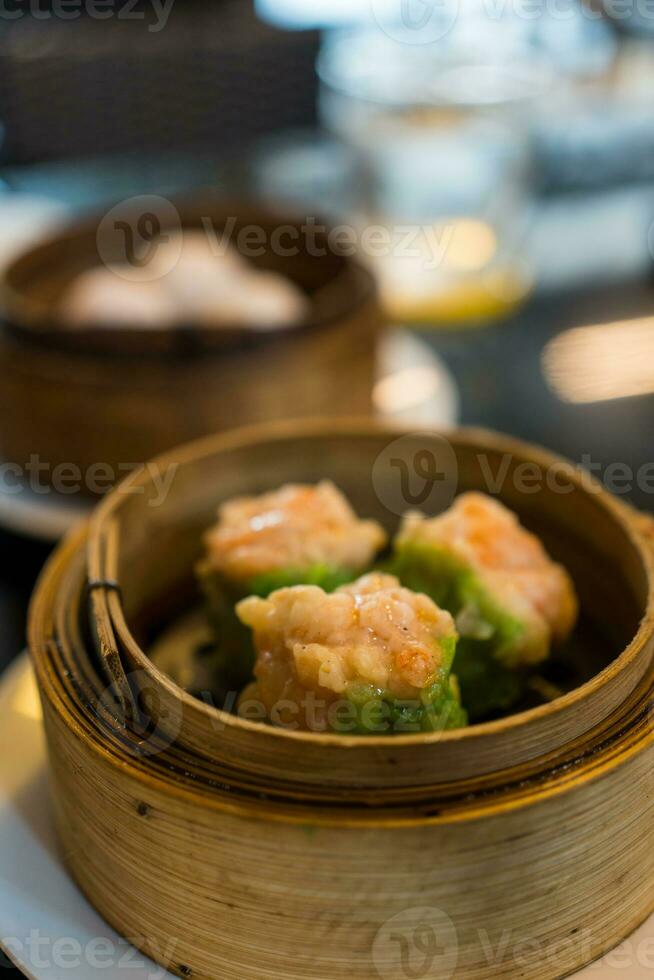 Shrimp dumplings in a bamboo steamer photo