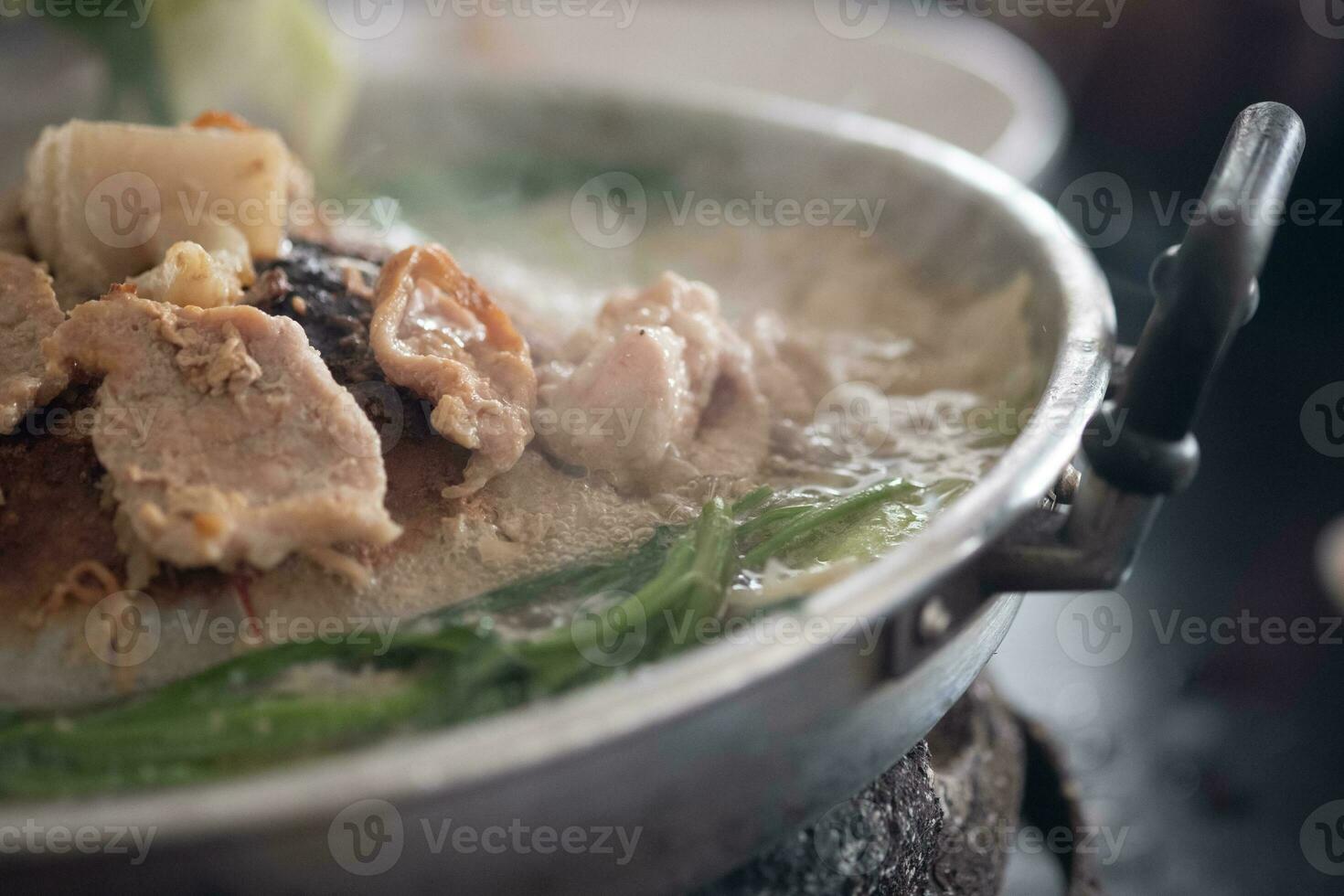 Pork or meat and vegetable grilling in pan on the stove. Thai barbecue buffet. Thai call Moo ka ta. photo