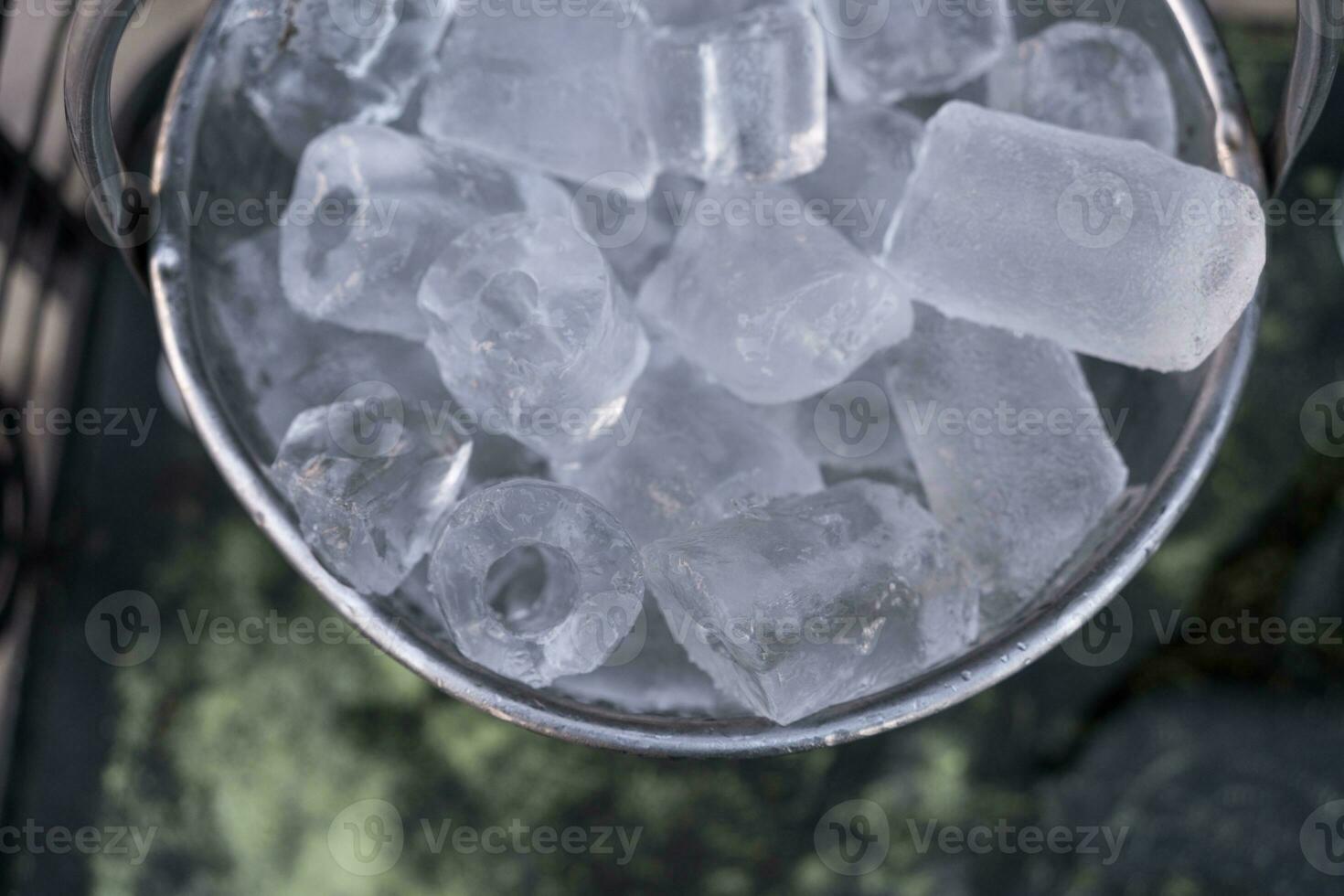 Metal bucket with ice cubes photo