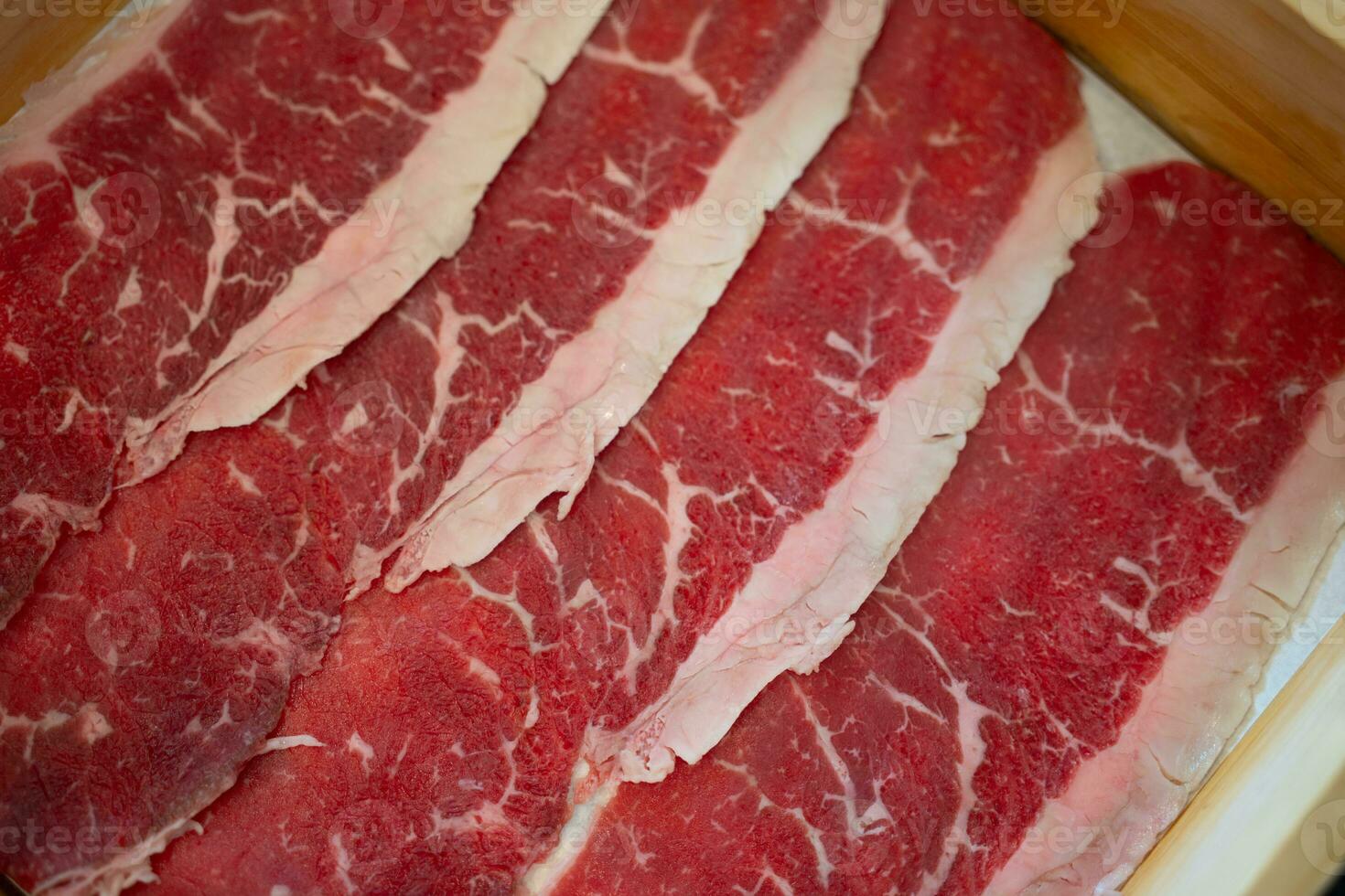 Fresh beef raw sliced with marbled texture photo